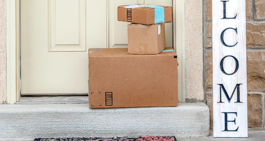 Deliveries on the front porch of a house with a welcome sign in Athens